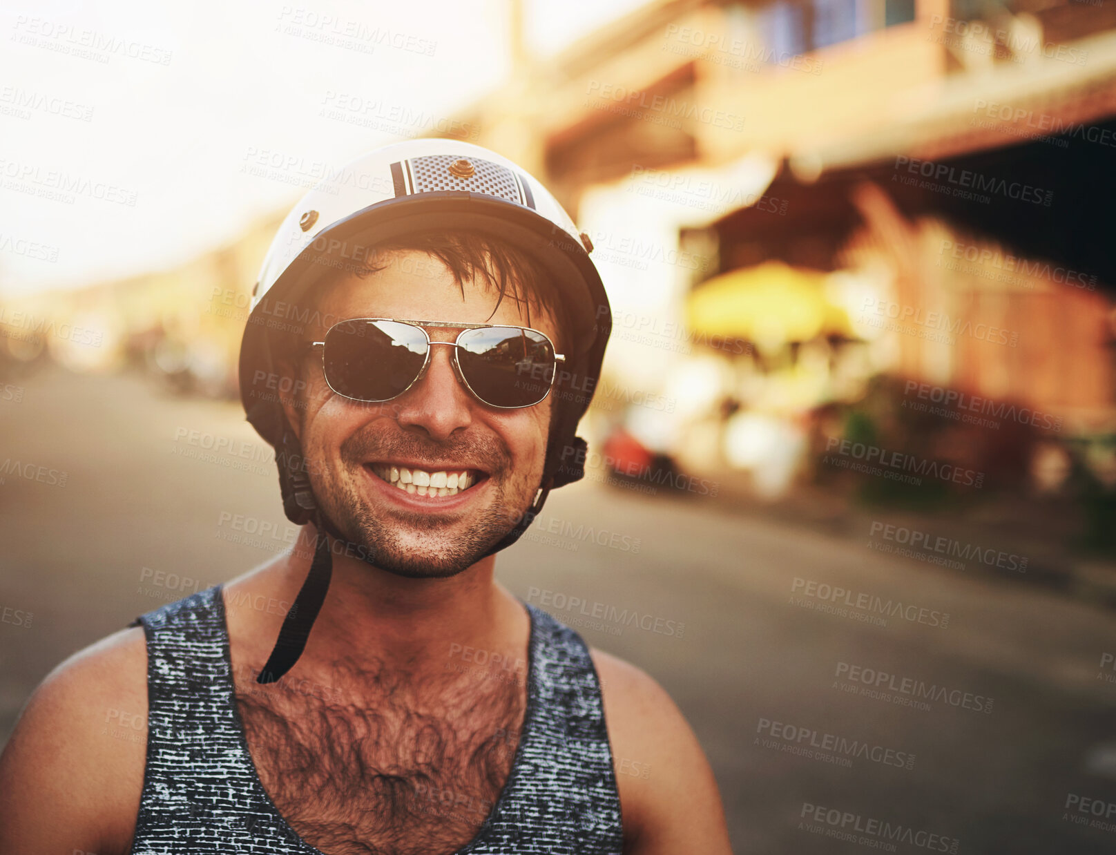 Buy stock photo Man, closeup and smile in city with helmet for commute, sunglasses on street for holiday. Male person, happiness and safety for travel in urban with buildings, cheerful on vacation in Costa Rica