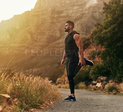 Buy stock photo Man, mountain and exercise with headphones in stretching for fitness, training and workout music. Male person, thinking and runner in nature with preparation for sport, balance or podcast for warm up