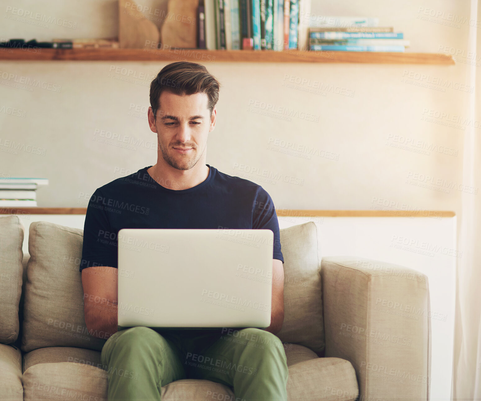 Buy stock photo Sofa, smile and man with reading on laptop at home for communication, information and online network. Relax, remote work and male person with technology for freelance website, research and connection