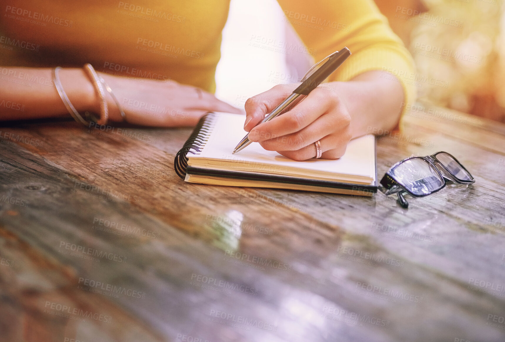 Buy stock photo Woman, closeup and notebook for notes, schedule and planning on table in cafe with pen. Wife, writing and notepad with marriage journal, diary and letter for self care, growth and relationship goals