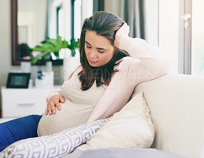 Buy stock photo Health, pregnancy and woman with hand on stomach  for comfort and support on sofa at home. Healthcare, female person or mother and wellness with worry and stress for belly in maternity on couch