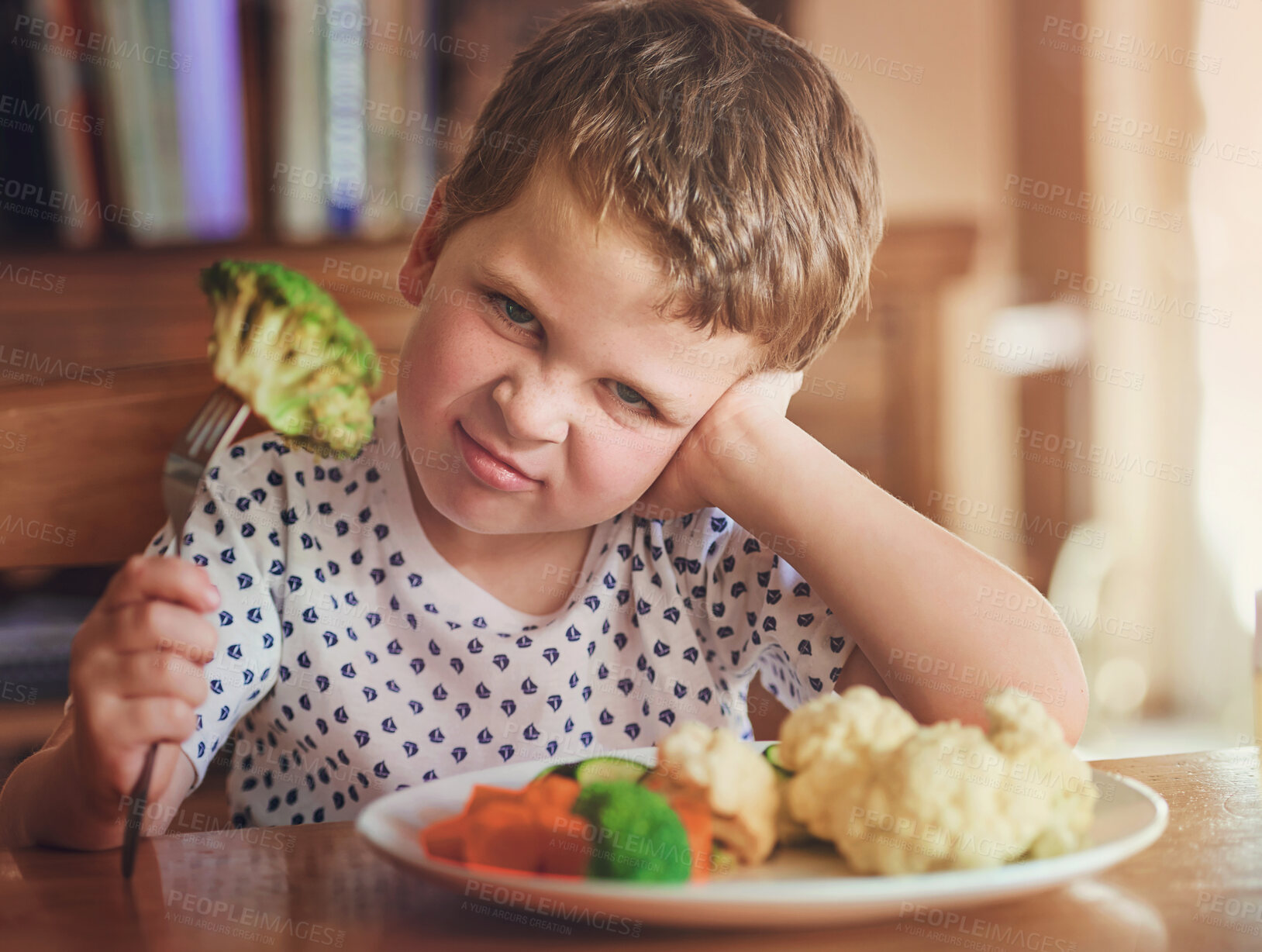 Buy stock photo Upset, young boy and reject food at dinner table for not eating vegetable and no to nutrition at home. Healthy, child and face with disgust for portrait or refuse balanced diet for fussy eater