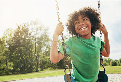 Buy stock photo Happy, nature and child on swing in park for fun, adventure and play time on holiday or weekend trip. Smile, cute and boy kid on motion equipment on playground in outdoor field on vacation in Brazil.