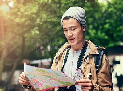 Buy stock photo Asian man, map and city travel for location directions or urban sightseeing in China, searching or reading. Male person, paper and guide for outdoor tourism for weekend journey, lost or geography