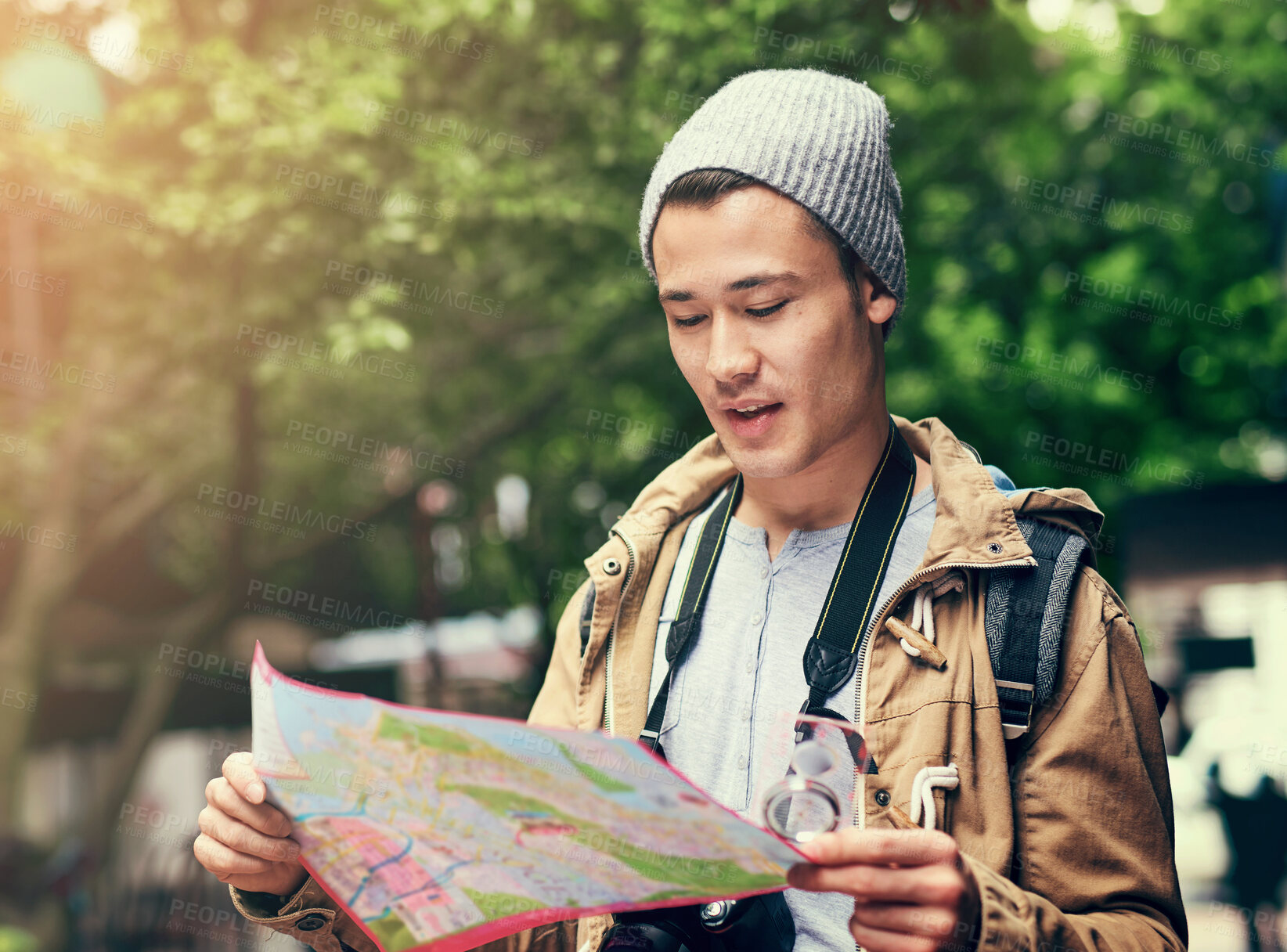 Buy stock photo Asian man, map and city travel for location directions or urban sightseeing in China, searching or reading. Male person, paper and guide for outdoor tourism for weekend journey, lost or geography