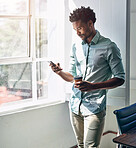 Office, window and black man with phone, coffee and scroll on social media, email or online chat. Networking, schedule and creative professional with smartphone for business connection with drink.