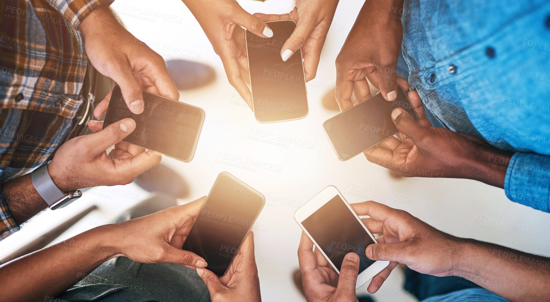 Buy stock photo Cellphone, hands and group of friends in circle networking online for email, social media or internet. Technology, typing and team of people with phone for text message on website from above.