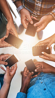 Buy stock photo Phone, hands and team of people in circle networking online for email, social media or internet. Technology, typing and group of friends with cellphone for text message on website from above.