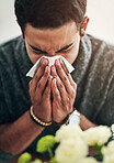 Face, hand and blowing nose with a man using a tissue in his home for relief from allergy symptoms. Sick, cold or flu disease and a young person ill with a virus due to bacteria, pollen or hay fever