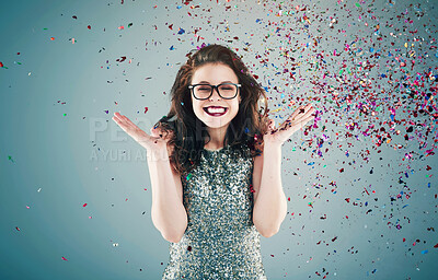 Buy stock photo Happy, celebration and woman on blue background with confetti for success, winning and birthday surprise. Winner, excited and isolated person with glitter for party, prize and achievement in studio