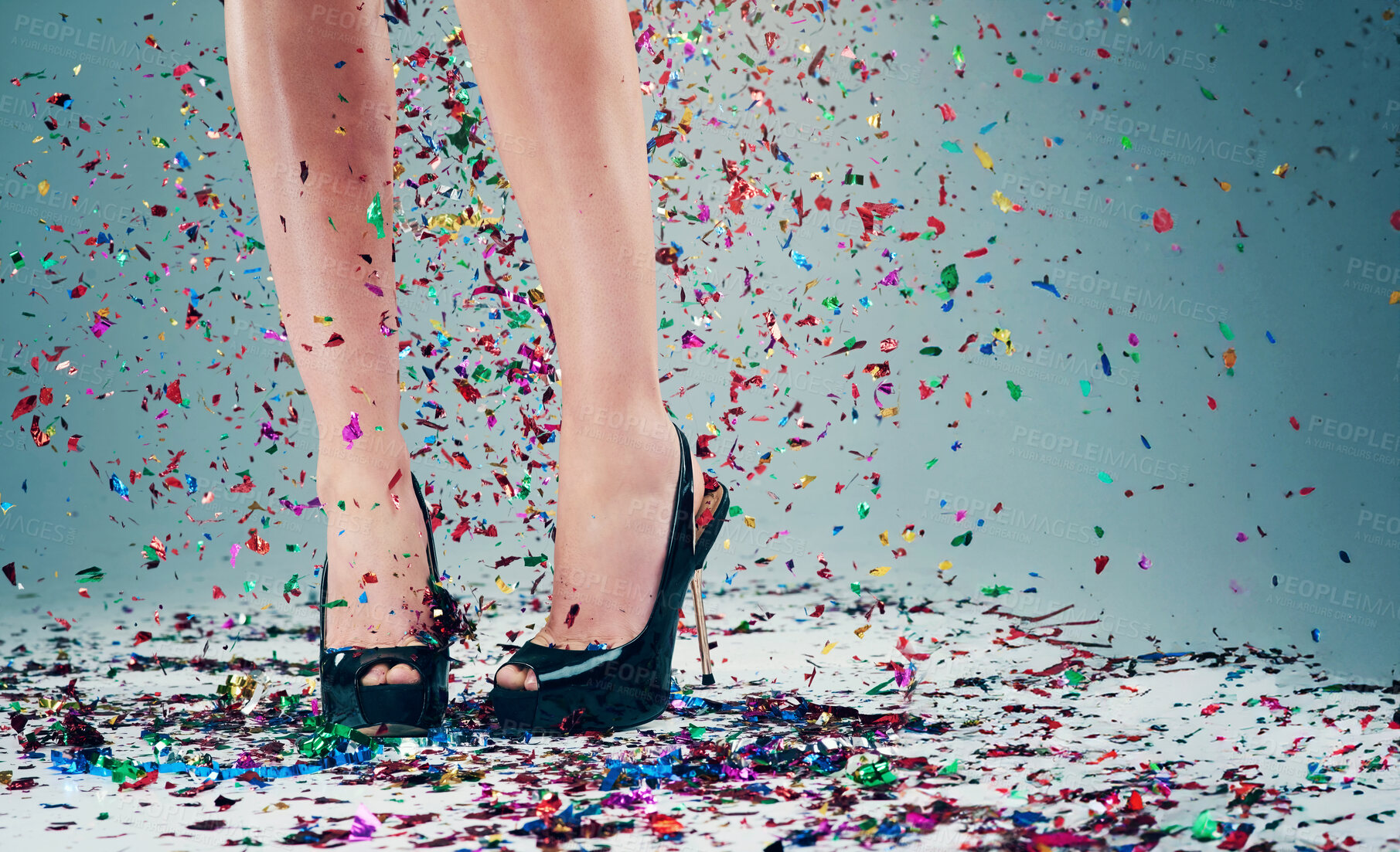 Buy stock photo Woman, legs and heels with confetti for celebration of new years, party and decoration for event. Person, shoes and sparkling sequins on floor for festive, birthday and surprise on studio background 
