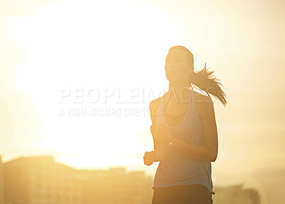 Buy stock photo Woman, running and silhouette in sunrise for exercise with mockup space in sky with buildings in city. Girl, person and athlete with training, workout or earphones for music streaming in metro street