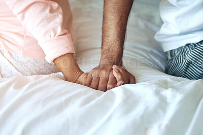 Buy stock photo Couple, holding hands and support in bed of home with empathy, compassion or connection in marriage. Mature, people and praying in bedroom with pyjamas, worship and faith with comfort or appreciation