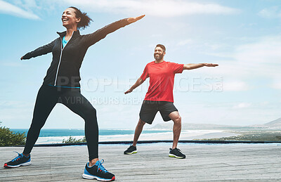 Buy stock photo Couple, stretching and arms for yoga outdoor with warm up, blue sky and morning activity for flexibility with smile. People, exercise and teamwork for fitness by ocean with wellness, happy or active 