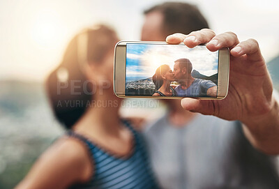 Buy stock photo Phone, selfie and couple kiss in nature outdoor on summer vacation together. Smartphone screen, romance and picture of man and woman in countryside for connection, memory of love and relationship