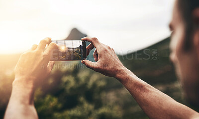 Buy stock photo Sunset, photography and hands of man with phone, screen and post on social media with nature, landscape or sun. Cellphone, photo and person with tech for memory of vacation, holiday or mountain view