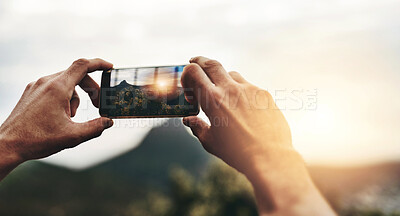 Buy stock photo Sunset, photography and hands of person with phone, screen or post on social media with nature, landscape or sun. Cellphone, photo or man with tech for memory of vacation, holiday or view of mountain