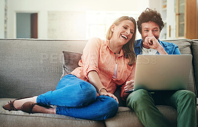 Buy stock photo Mature, couple and laughing with laptop on sofa for comedy movie, funny series or streaming service in home. People, technology and comic video on couch with relax, bonding or entertainment in lounge