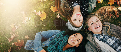 Buy stock photo Above, friends or girls on grass for lying, relaxing and bonding together in park with happiness. Nature, lawn and teenagers on summer holiday for chilling, hanging out and laugh outdoors with smile