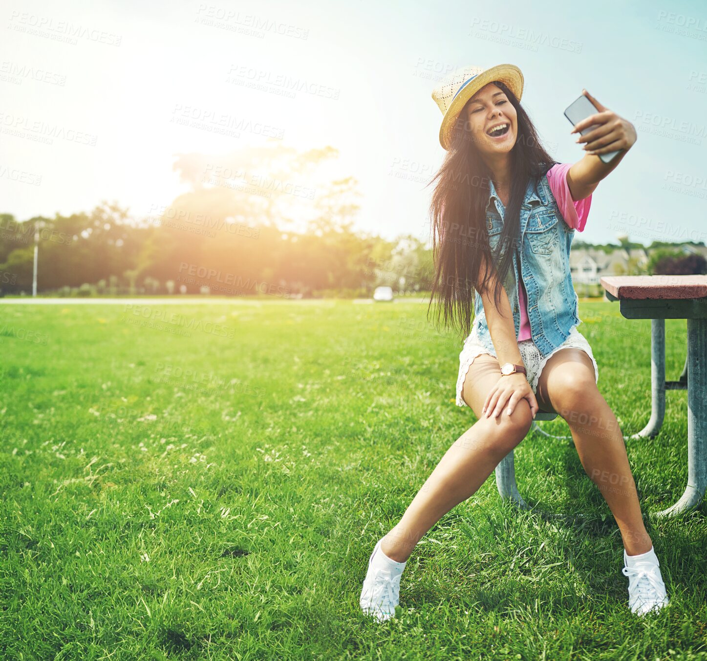 Buy stock photo Smile, girl and selfie on bench in park for profile picture on social media or memory of summer vacation in California. Woman, sunshine and holiday with photography or live blog for content creation.