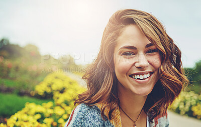 Buy stock photo Woman, portrait and flowers with smile for travel in autumn environment, countryside or outdoor. Female person, face and floral daisies in sunshine with happiness for England trip, meadow or holiday