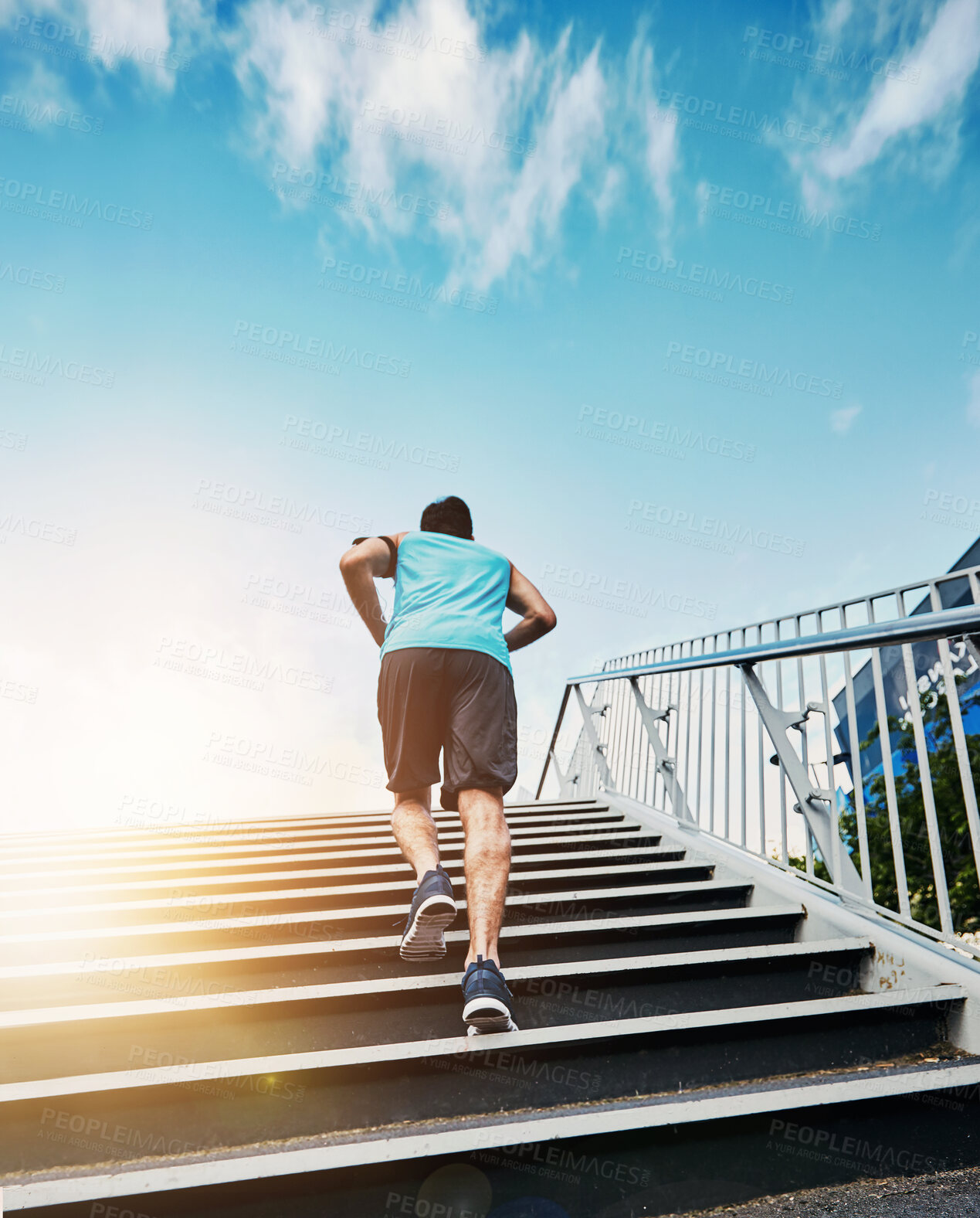 Buy stock photo Back, fitness and running with man, stairs and exercise with progress, sunshine and challenge. Rear view, steps and runner in city, lens flare or training for wellness, healthy or energy with workout