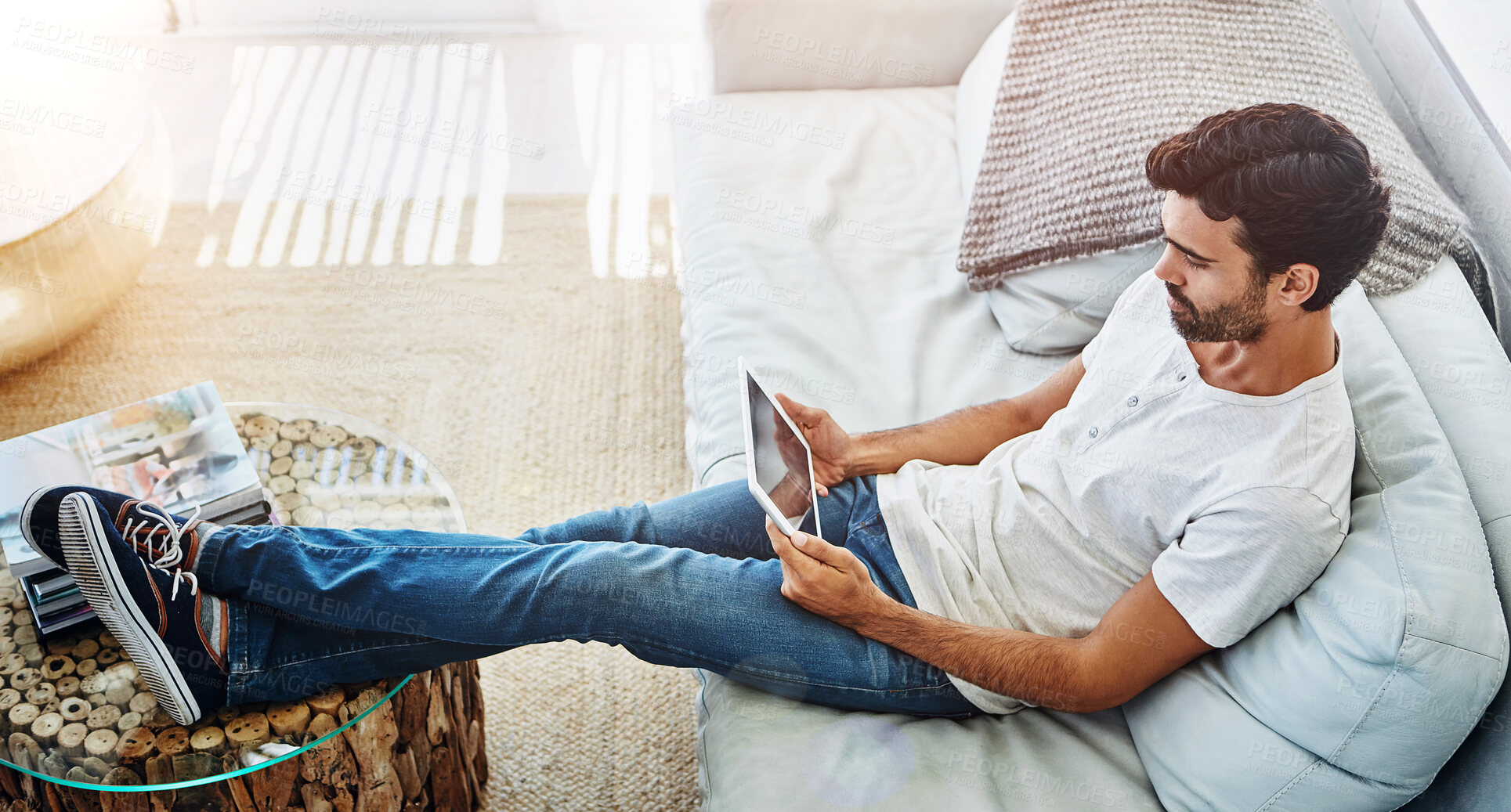 Buy stock photo Couch, man and tablet in house or relax, scrolling and online for internet search and watching video on streaming website. Email, social media and communication technology, comfort and weekend break