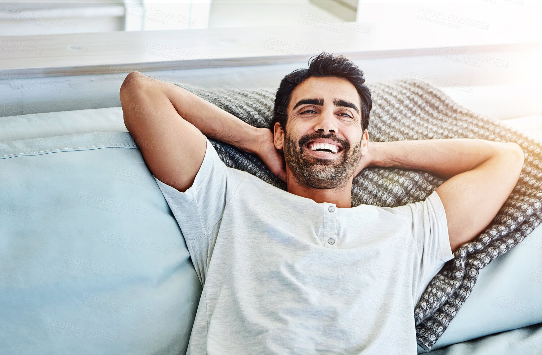 Buy stock photo Happy man, relax and lying on couch for leisure, resting and weekend break in living room. Happiness, cozy and male person with arms out on sofa for lazy Saturday, comfortable or day off in home