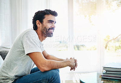 Buy stock photo Relax, home and thinking with man, smile and ideas with sunshine, weekend break and wonder. Happy person, apartment and guy in living room, thoughts and chilling with lens flare, peaceful and calm