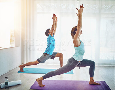 Buy stock photo Pilates, stretching and couple in living room for fitness, spiritual wellness and workout in home. Yoga, health and yogi woman with man for warrior pose exercise, balanced chi or healing lifestyle