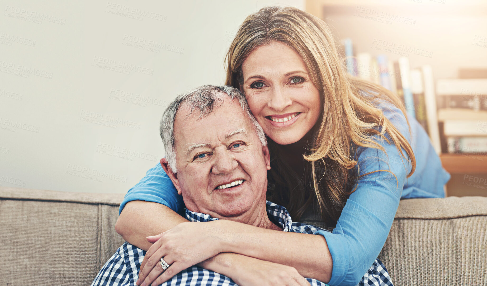 Buy stock photo Hug, portrait and senior man with woman in living room for happiness, love and bonding together in home. Lens flare, smile and father with daughter on sofa for embrace, family reunion or weekend.