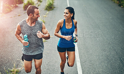 Buy stock photo Fitness, running and couple with smile, exercise and bottle for hydration with water and outdoor. Road, race and people in morning, sportswear and training together, energy and workout in routine