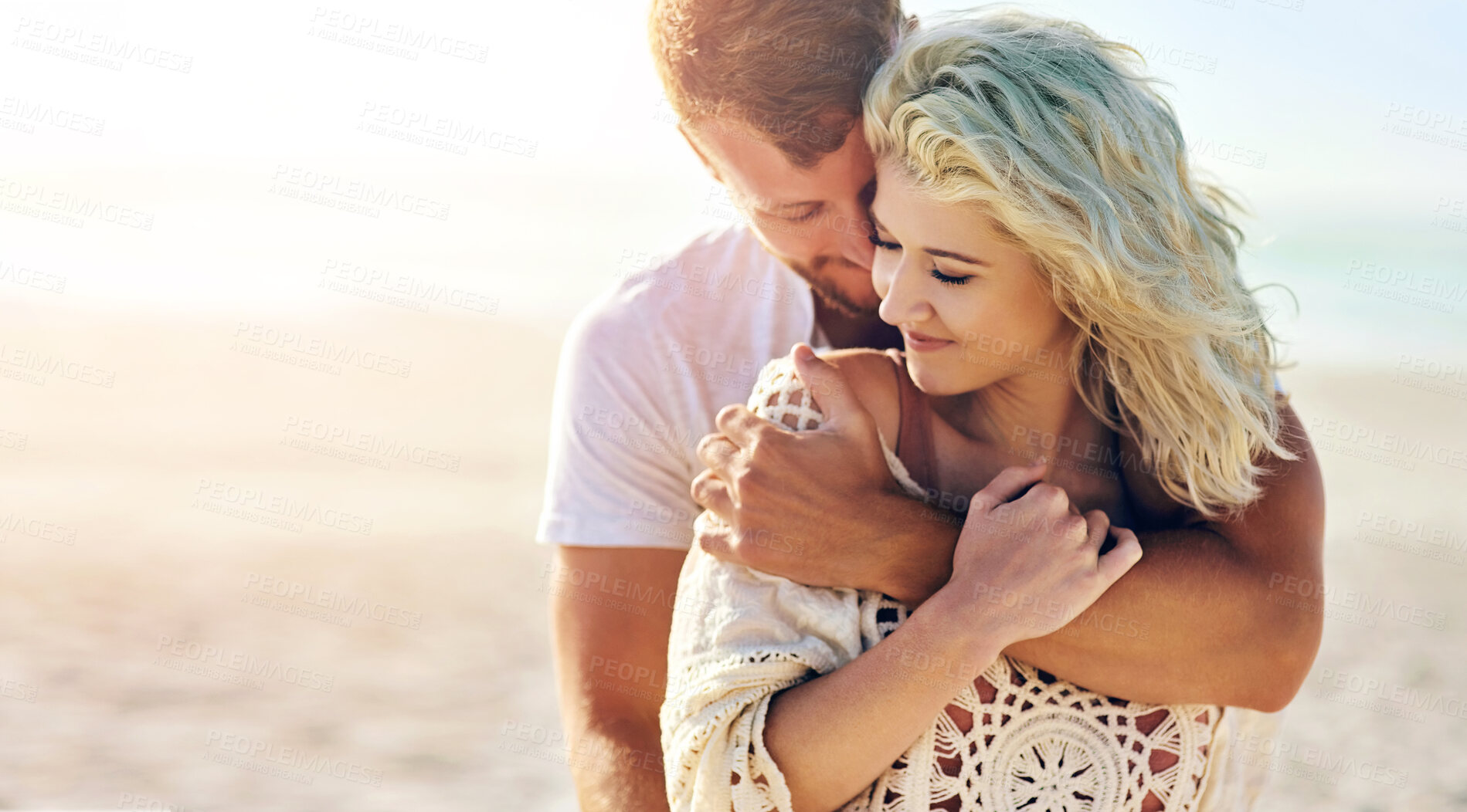 Buy stock photo Happy, couple and hug by ocean with love for seaside romance, serene seascape and beach view with affection. Man, woman and together for bonding by coast on weekend date, embrace and mockup with care