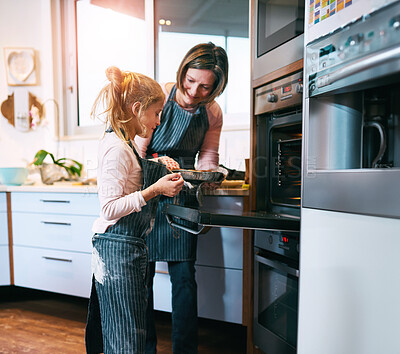 Buy stock photo Mom, girl and baking in kitchen with oven for handmade pie and bonding while learning, help and together. Mother, daughter and home for teaching skills, growth development and love for cooking.