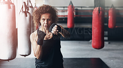 Buy stock photo Fitness, punching bag and mature woman in gym for exercise, boxing challenge or competition training. Power, muscle and champion boxer at workout with confidence, fight and energy in MMA sports club.