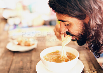 Buy stock photo Chinese food, man and eating noodles at restaurant for lunch, dinner or healthy diet in bowl. Ramen, soup and hungry person with chopsticks for meal, nutrition or cuisine for tourist at cafe table