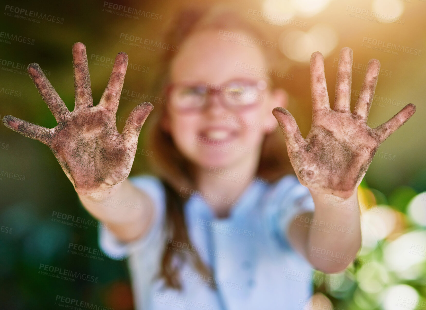 Buy stock photo Portrait, hands and kid with soil, environment and sunshine with nature, climate change and playful. Face, girl and fun with childhood, dirt and muddy with mess, outdoor and summer with weekend break