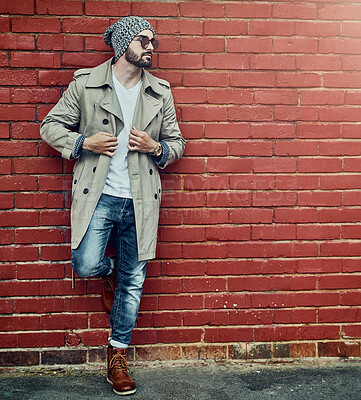 Buy stock photo Man, brick wall and urban fashion outdoor with streetwear or city style, denim and cap with trendy or stylish clothes. Thinking, cool and modern designer jeans with capsule wardrobe and attitude.