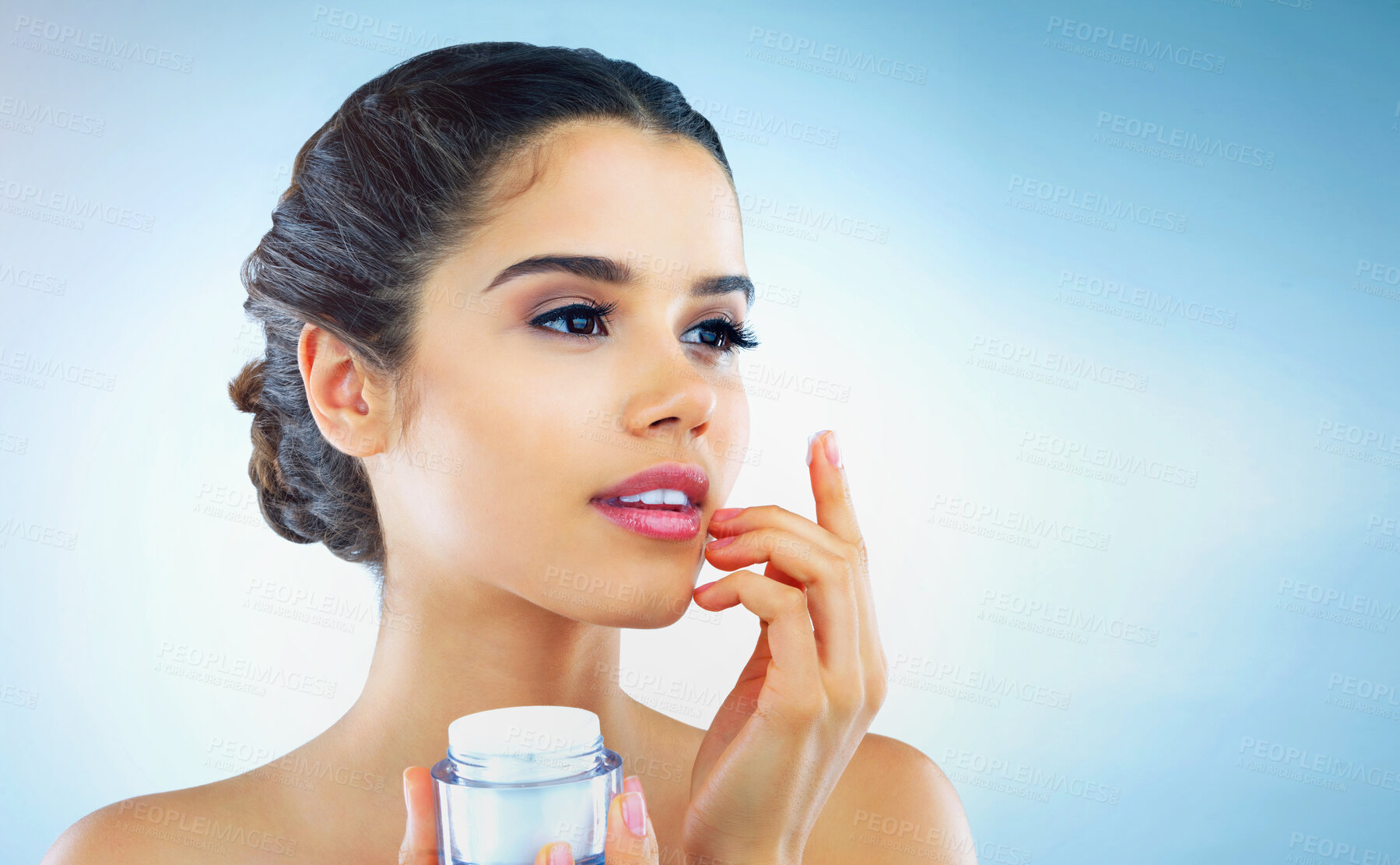 Buy stock photo Cream, beauty and woman on blue background for skincare, wellness and facial treatment in studio. Dermatology, salon and face of isolated person with moisturizer, lotion and anti aging cosmetics