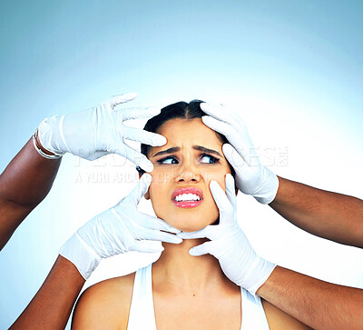 Buy stock photo Hands, gloves and woman scared in studio for skincare, plastic surgery and face consultation. Female model, shock and stress for facial change, treatment or doctors for dermatology by blue background