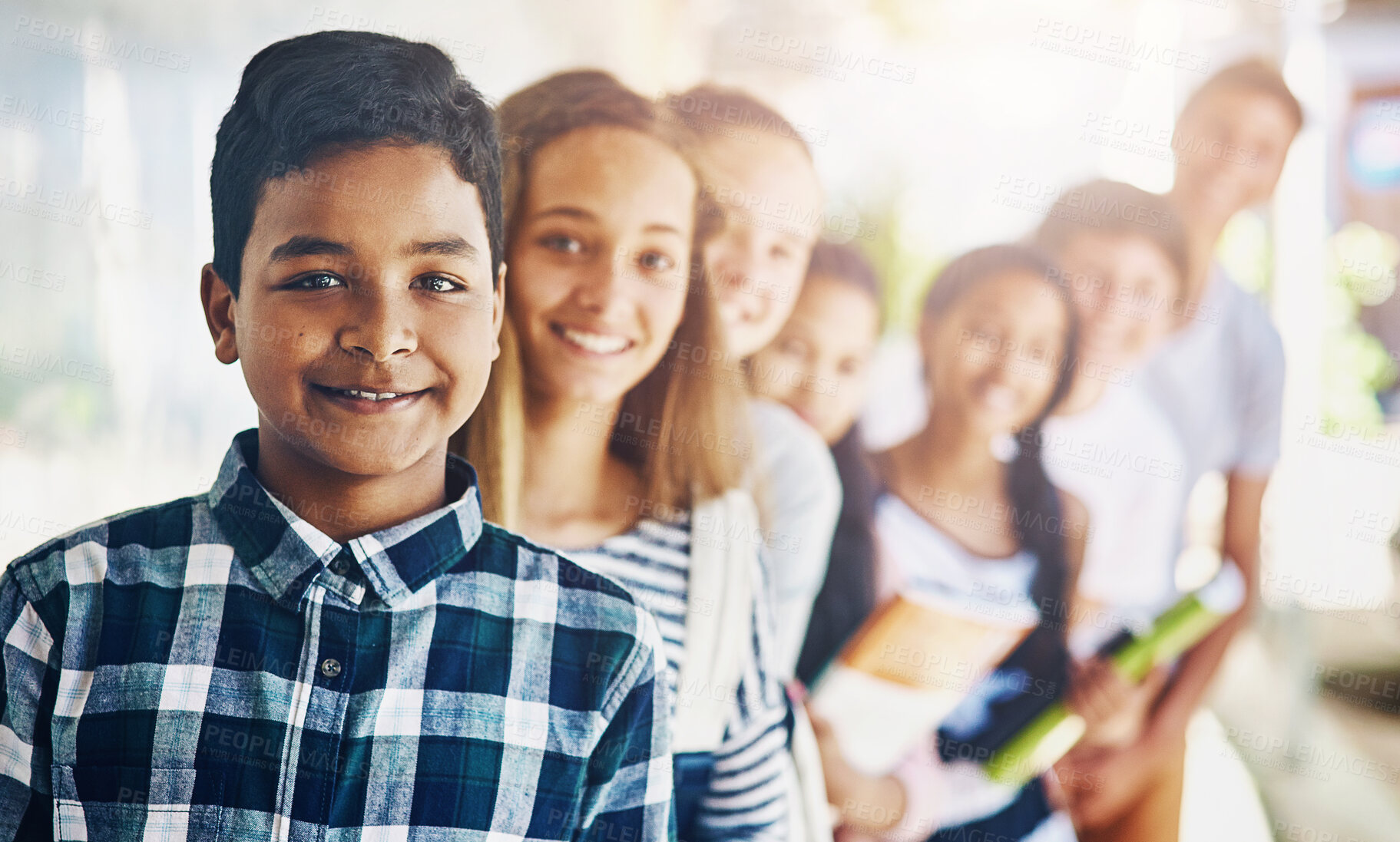 Buy stock photo Boy, portrait and group of students in line at school with smile, confidence and scholarship outdoor. Children, friends and happy or waiting in row outside classroom for education, study and learning