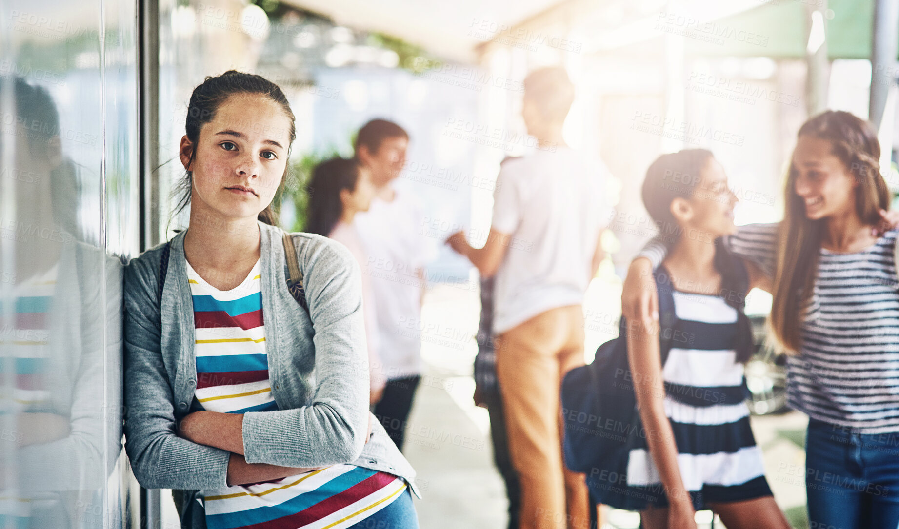 Buy stock photo Young girl, portrait and lonely with school bag outside classroom in learning academy or institute. Female person, teenager or learner leaning on glass wall alone with arms crossed at outdoor campus