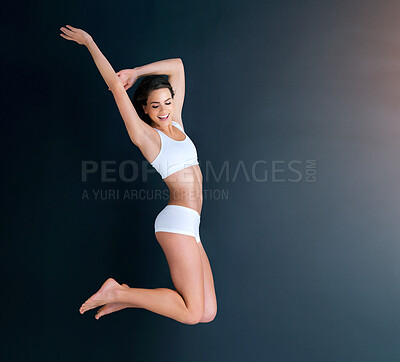 Buy stock photo Woman, jump and wellness with healthy body, fitness and excited face for wellness, mockup space or smile. Model, girl and jumping with underwear, exercise and background for lifestyle, workout or joy