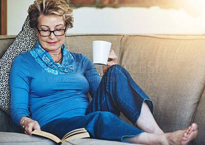 Buy stock photo Senior woman, book and coffee with living room, sofa and relaxing for retirement rest. Lady, cup and warm beverage with novel, reading and house for entertainment, study or knowledge with story