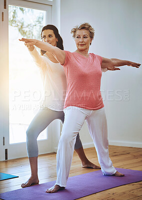 Buy stock photo Mature woman and yoga instructor helping with warrior pose for exercise at fitness class for wellness. Health, female person and coach for workout guidance, instruction and support for body posture  