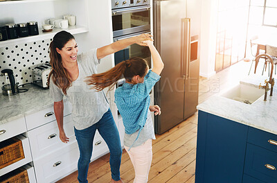 Buy stock photo Happy, mother and girl dance in kitchen with love, care and support in family or home on weekend. Excited, energy and mom relax with kid in morning or bonding, holding hands and spinning from above