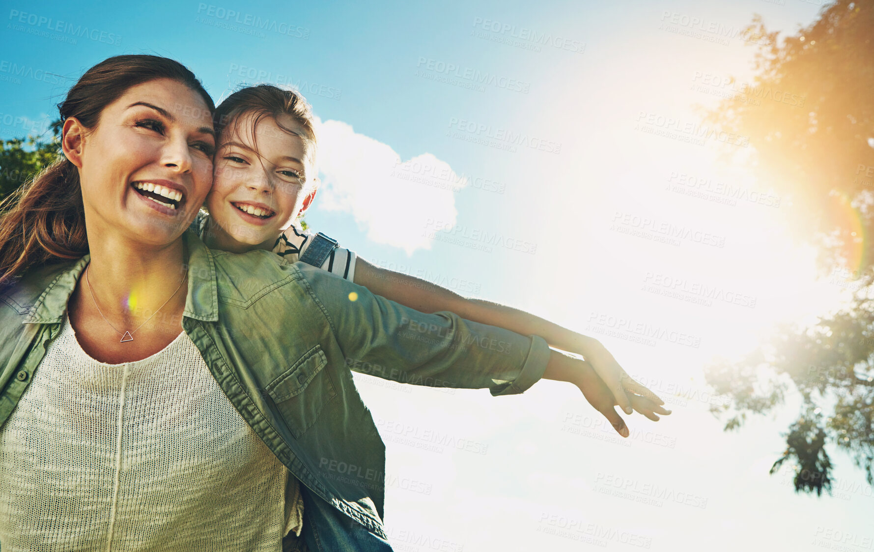 Buy stock photo Mother, daughter and plane on back with playing outdoor in nature with blue sky, sunlight and bonding in garden. Happy family, woman and girl child with flying game for fun activity and entertainment