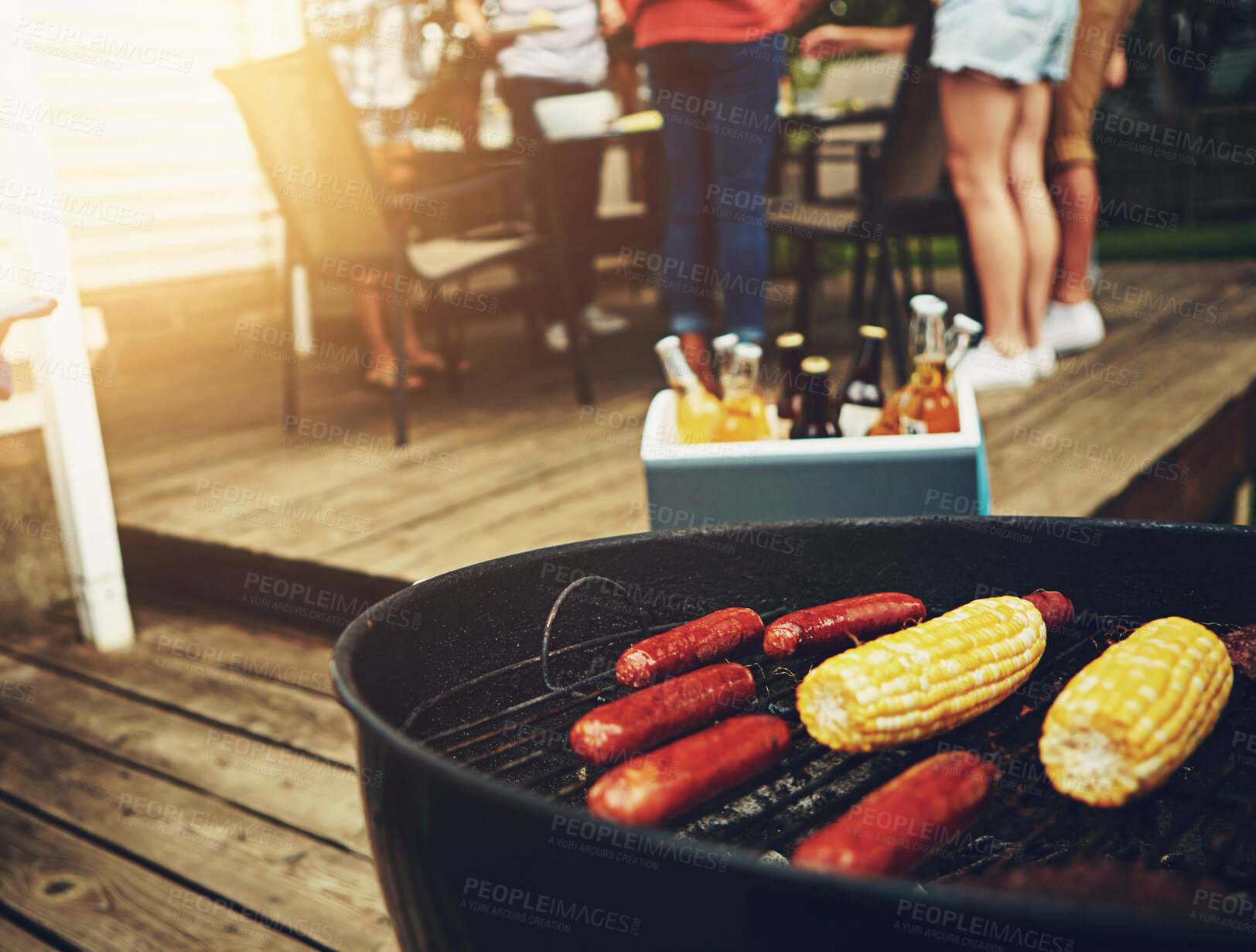 Buy stock photo Outside, food and barbecue on weekend with grill for corn, sausage and cooking on porch or backyard. Drinks, friends and celebration party with reunion, meal and summer in America with family.