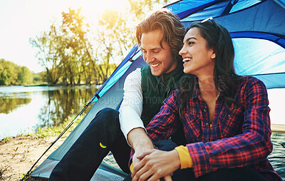 Buy stock photo Camping, holiday and couple in tent with love and happiness together on adventure in woods at lake. People, embrace or relax outdoor in nature with funny chat on vacation or travel to river in forest