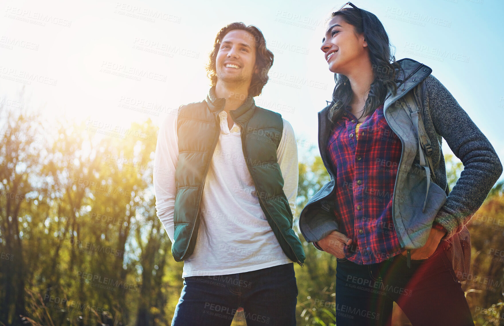 Buy stock photo Happy, young couple in park or nature together for holiday, vacation and romantic weekend break. Smiling, man and woman relax in forest or green environment for peace, freedom and summer travel 